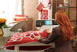 Quilter using the BERNINA 790 ULTRA to quilt a red and white star quilt